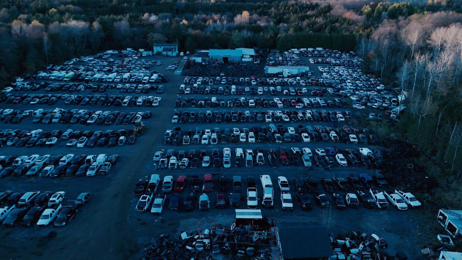 Aerial view of the GTA Auto Recycling yard in Newcastle, Clarington, with the yard buildings at the back and rows of cars in front